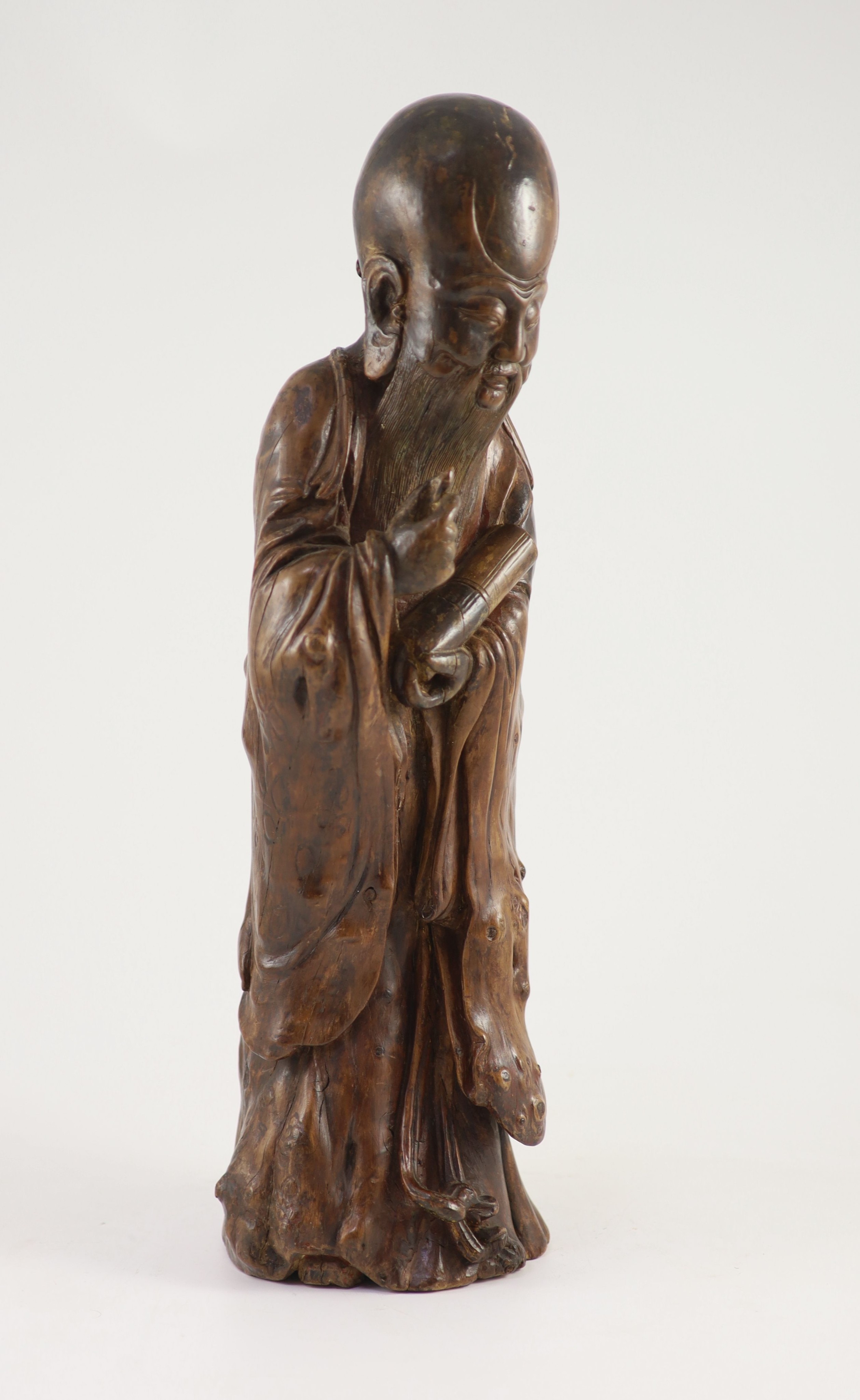 A tall Chinese rootwood figure of Shou Lao, 17th/18th century, 46 cm high, missing the staff in his right hand